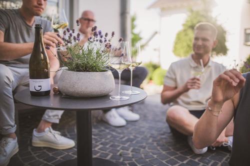 a group of people sitting around a table with wine glasses at Weingut Gehlen-Cornelius in Brauneberg
