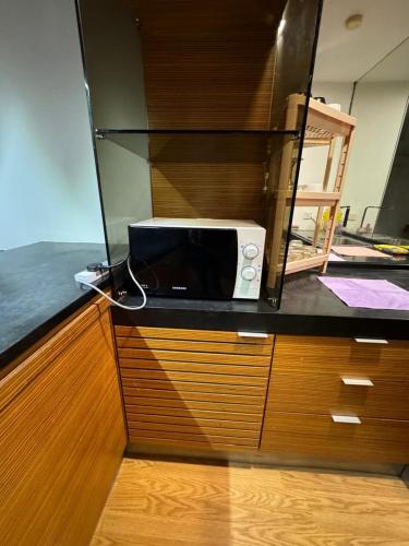 a microwave sitting on top of a counter at KL Sentral Dua Sentral Cozy Homestay Apartments by Hollywood Homes #FreeCarPark in Kuala Lumpur
