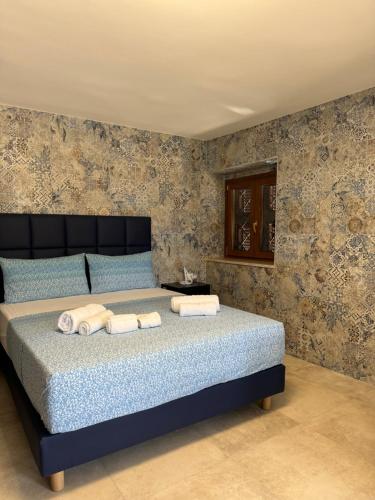 a bedroom with a bed with towels on it at Edo House Anzio - Beachfront - Fronte Mare - Affittacamere in Anzio