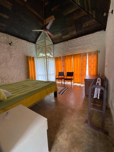 a bedroom with a bed and a table in a room at T Stop Estate in Kurchi