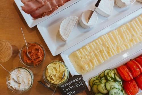 a table with different types of cheese and other foods at Weingut Gehlen-Cornelius in Brauneberg