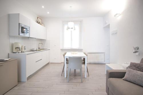 a kitchen and living room with a table and a couch at Cinque Terre Bridge in La Spezia