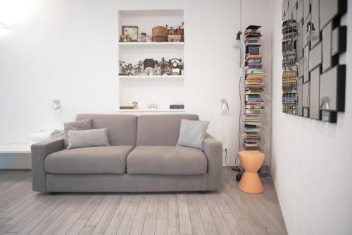 a living room with a gray couch in a room at Cinque Terre Bridge in La Spezia