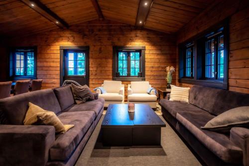 a living room with couches and a coffee table at Trysilfjellet Nord 170 in Trysil