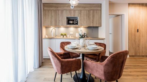 a dining room with a table and chairs at VacationClub Apartamenty Zakopiańskie Apartament 250 in Zakopane