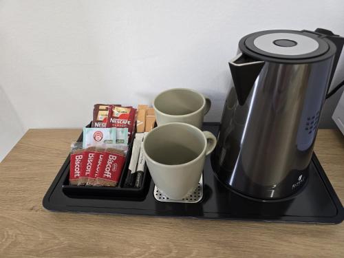 a black tray with cups and coffee cups on a table at Modular Suites Alfonso Gómez in Madrid