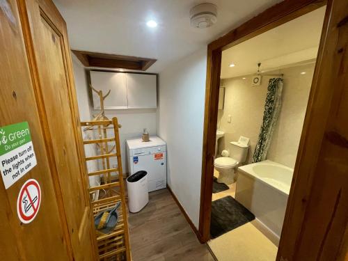 a bathroom with a tub and a toilet and a sink at Yairbrig Holiday in Galashiels
