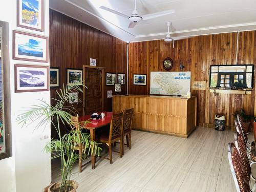a conference room with a table and chairs and wooden walls at Shangrila Fairymeadows Inn in Tato