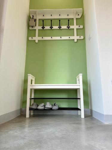 a shelf in the corner of a room with shoes at Suite Gioconda a Pienza in Pienza