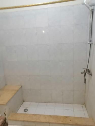 a bathroom with a shower with a tub and a tile floor at Rezeiky Hotel & Camp in Luxor