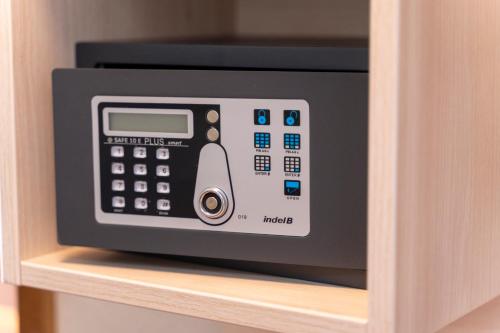 a microwave oven sitting on a shelf in a cabinet at Hotel Unter den Linden in Rüdesheim am Rhein