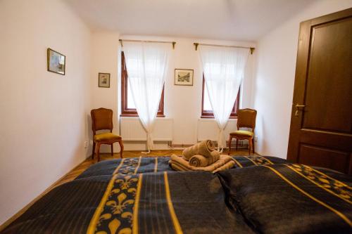 a bedroom with a bed with a stuffed animal on it at Apartment Ztracená 8 in Olomouc
