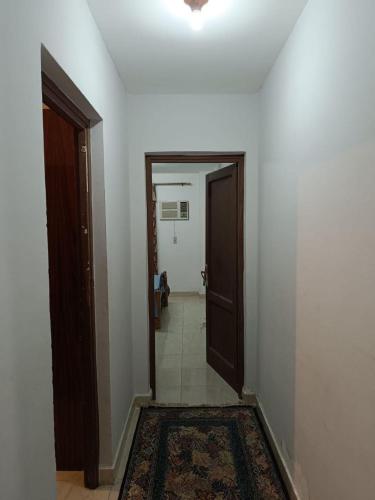 an empty hallway with a door and a rug at apartment b1 AL2 in Madinaty