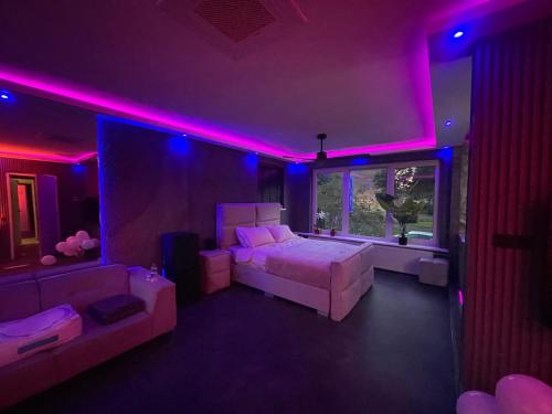 a bedroom with a bed and purple lights at Spartementen by Pure-Zen in Rotterdam