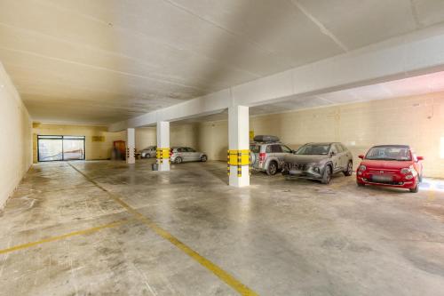an empty parking garage with cars parked in it at Villagg tal-Fanal in Għasri