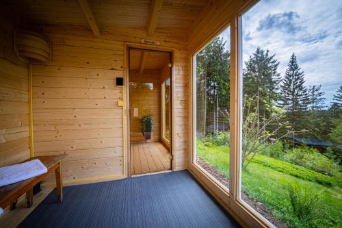 an inside view of a wooden cabin with a large window at Sonnenhäusle - Natur. Fernblick. Panorama-Sauna. in Sasbachwalden