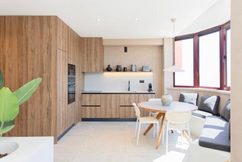 a kitchen and living room with a table and chairs at Liiiving in Gaia - Panoramic Terrace Penthouse in Vila Nova de Gaia