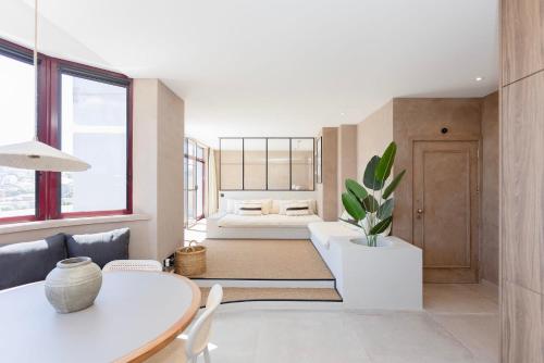 a living room with a table and a bed at Liiiving in Gaia - Panoramic Terrace Penthouse in Vila Nova de Gaia