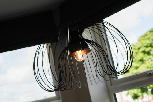 a light that is hanging from a window at The Olive Tree Aparthotel in Hull