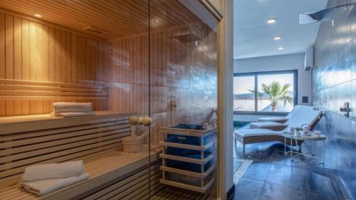 a sauna with a bench and a table in a room at Luxury Villa Milly Heated indoor and outdoor pool in Vrh