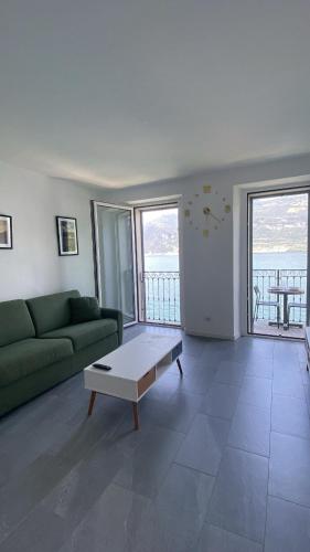 a living room with a green couch and a coffee table at Lake Mirror in Lezzeno