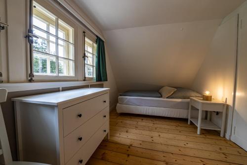 a small bedroom with a bed and a window at Sonnenhäusle - Natur. Fernblick. Panorama-Sauna. in Sasbachwalden