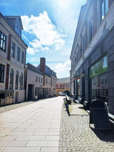 an empty street in a city with buildings at Grand 4 Persons Family Room With Free Parking in Hjørring