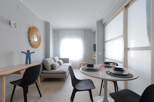 a living room with a table and a couch at Elegant 2 Bedrooms Flat 5 minutes from the sea & free parking in Puerto del Rosario