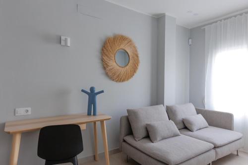 a living room with a couch and a mirror at Elegant 2 Bedrooms Flat 5 minutes from the sea & free parking in Puerto del Rosario