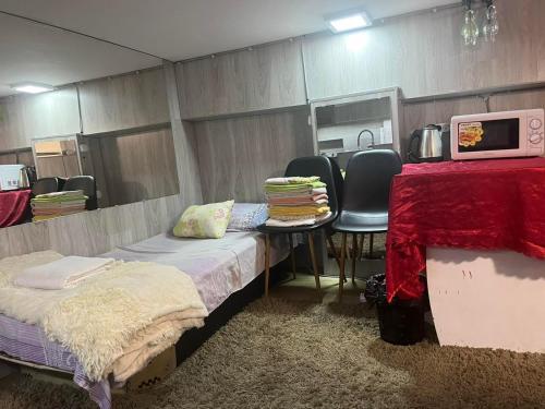 a room with two beds and a table and chairs at Luxury studio in Chişinău