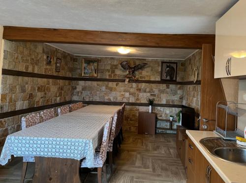 a kitchen with a table with chairs and a sink at Villa Garden in Kremen