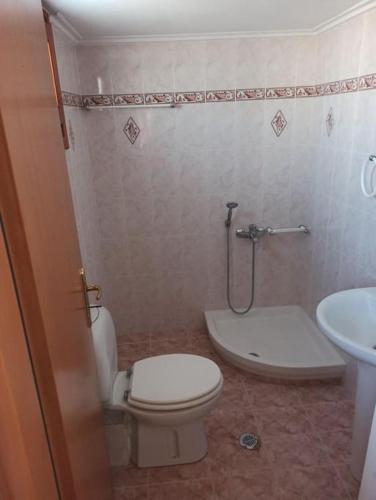 a bathroom with a toilet and a sink at Nea Peramos Apartment-2 in Nea Peramos