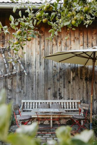a wooden fence with a table and an umbrella at Staudingerhof in Staudach-Egerndach
