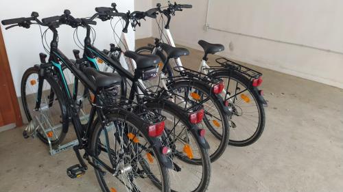 a group of bikes parked in a garage at Végvár Spa Apartman in Gyula