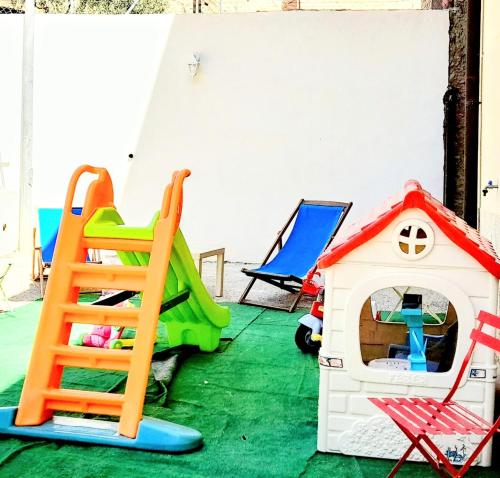 a room filled with play equipment and a play house at Appartamento Castel Sant'Angelo in Licata