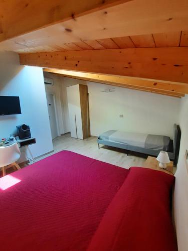 a bedroom with a bed and a red rug at La Macchia in Santo Stefano di Magra