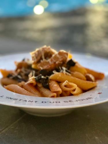 a plate of food with pasta on a table at L'instant d'un séjour in Le Guâ