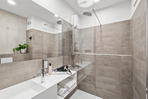 a bathroom with a sink and a shower at Nena Apartments München City East in Munich
