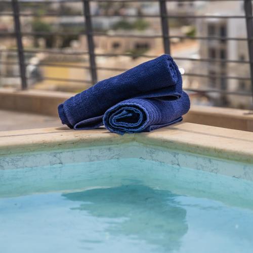 a blue towel sitting next to a swimming pool at Mellieha Penthouse with pool and view by Homely in Mellieħa