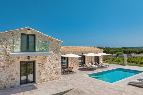 an image of a villa with a swimming pool at Villa Nava - Nestled in Olive Trees with Private Pool, by ZanteWize in Alykes