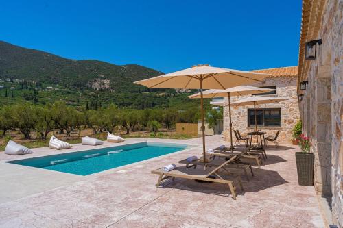a patio with chairs and umbrellas and a pool at Villa Nava - Nestled in Olive Trees with Private Pool, by ZanteWize in Alykes