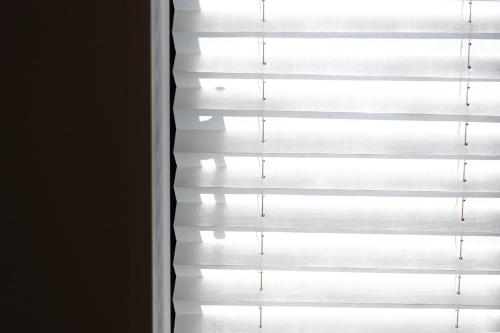 a blackout blind in a window at Mova Villa Ozu in Ozu