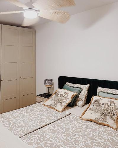 a bedroom with a bed with pillows and a ceiling at Sunny La Mata Apartment, Spain in La Mata