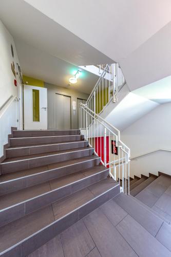 an empty stairwell in a building with stairs at A&T Hotel & Hostel in Vienna