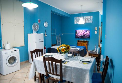 a dining room with a table and a blue wall at Dimora Del Cilento in Roccadaspide