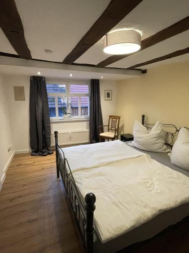 a bedroom with a large bed and a window at Thum'scher Hof in Ortenberg