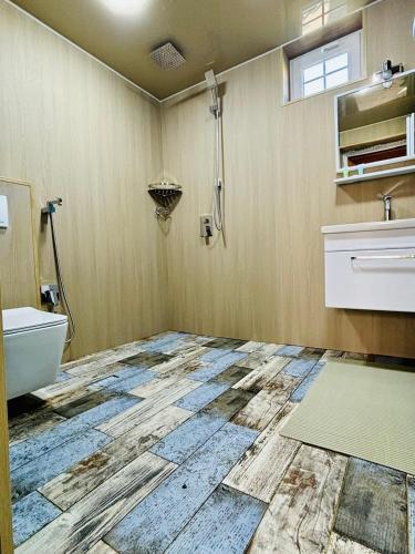 a bathroom with a toilet and a sink at Luxurious Cottages in Batumi with a Pool in Batumi