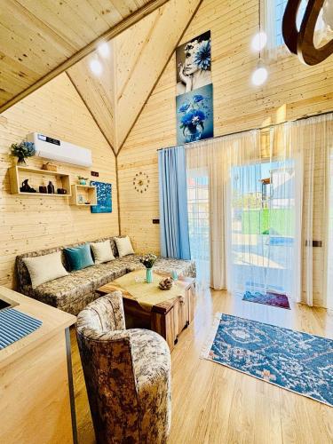 a living room with a couch and a table at Luxurious Cottages in Batumi with a Pool in Batumi