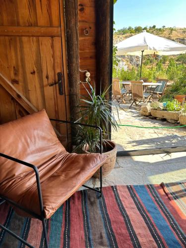 a chair sitting in front of a door at Potamia Cave Suites in Ortahisar