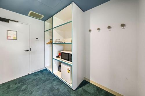 a room with white walls and a white refrigerator at The Lodge, Blacktown - Sydney in Rooty Hill